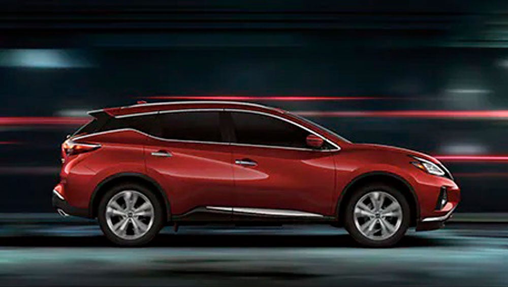 2023 Nissan Murano shown in profile driving down a street at night illustrating performance. | Valley Nissan in Longmont CO